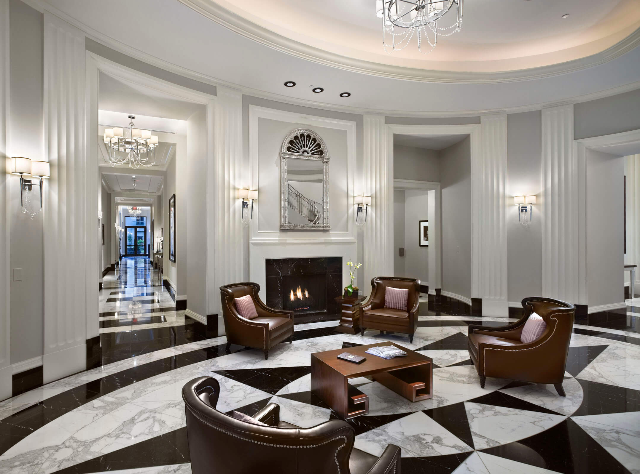 Waldorf Astoria Atlanta Buckhead lobby with marble floors, lounge chairs and a fireplace